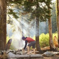 Shot of a man cooking food over a fire while out campinghttp://195.154.178.81/DATA/i_collage/pu/shoots/806105.jpg