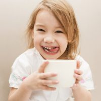Little cute and sweet girl with tea